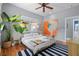 Cozy bedroom featuring hardwood floors, plants, and unique artwork at 382 Race St # A, Charleston, SC 29403
