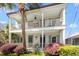 Charming two-story home with double porches, lush landscaping, and a beautiful palm tree in the front yard at 382 Race St # A, Charleston, SC 29403