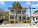 Lovely two-story home with a welcoming porch, mature landscaping, and vibrant flowering bushes at 382 Race St # A, Charleston, SC 29403