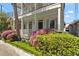 Inviting two-story home with a porch, framed by vibrant landscaping, showcasing curb appeal and a welcoming facade at 382 Race St # A, Charleston, SC 29403