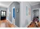 Inviting hallway featuring hardwood floors, neutral paint, and glimpses of a well-appointed bathroom at 382 Race St # A, Charleston, SC 29403