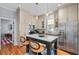 Beautiful kitchen featuring an island with seating, pendant lighting, modern appliances, and ample cabinet space at 382 Race St # A, Charleston, SC 29403
