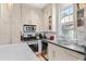 Modern kitchen with white cabinets, subway tile backsplash, stainless steel appliances, and a window over the sink at 382 Race St # A, Charleston, SC 29403