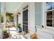 Inviting porch with a cozy bench, plants, and charming details at 382 Race St # A, Charleston, SC 29403