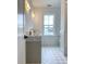 Elegant bathroom with marble countertop, dual sinks, and a window providing natural light at 3889 Summerton St, Mount Pleasant, SC 29466