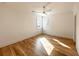 Bright and airy bedroom featuring hardwood floors, a ceiling fan, and two large windows at 3889 Summerton St, Mount Pleasant, SC 29466