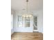 Chic dining area features hardwood floors, a modern chandelier, and access to a porch at 3889 Summerton St, Mount Pleasant, SC 29466