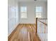 Bright hallway with hardwood flooring, wainscoting, and two windows providing natural light at 3889 Summerton St, Mount Pleasant, SC 29466
