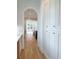 Hallway view showcases arched entryway and white cabinetry with gold hardware and hardwood flooring at 3889 Summerton St, Mount Pleasant, SC 29466