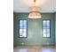 Living Room featuring decorative paneling, dark window trim, hardwood floors, and elegant pendant lighting at 3889 Summerton St, Mount Pleasant, SC 29466