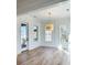 Open living space with hardwood floors, white trim, windows, and modern lighting at 3889 Summerton St, Mount Pleasant, SC 29466