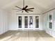 Relaxing covered porch with wood ceiling, ceiling fan and multiple doors leading inside at 3889 Summerton St, Mount Pleasant, SC 29466