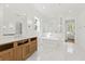 Light-filled bathroom featuring marble floors, a soaking tub, an open shower, a vanity with a quartz countertop, and recessed lighting at 3893 Summerton St, Mount Pleasant, SC 29466