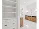 The bathroom features built-in storage, double vanities, marble floors, and lots of light at 3893 Summerton St, Mount Pleasant, SC 29466