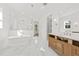 Bright bathroom with a freestanding tub, shower with glass surround, wood vanity, and marble tile at 3893 Summerton St, Mount Pleasant, SC 29466