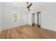 Bedroom featuring hardwood floors, white walls, modern ceiling fan, and sliding glass doors at 3893 Summerton St, Mount Pleasant, SC 29466