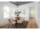 Bright dining room featuring a modern chandelier, a wood table with seating for six, and natural light from a window at 3893 Summerton St, Mount Pleasant, SC 29466