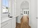 Bright white kitchen features a modern sink, quartz countertops, cabinetry, and view to additional rooms at 3893 Summerton St, Mount Pleasant, SC 29466