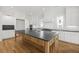 Bright open kitchen features an oversized center island, stainless appliances, and custom cabinetry at 3893 Summerton St, Mount Pleasant, SC 29466