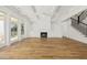 Bright open living room with a fireplace, hardwood floors, and access to an outdoor patio at 3893 Summerton St, Mount Pleasant, SC 29466