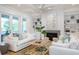 Bright living room features neutral furniture, a fireplace, built-in shelves, and patio doors for indoor-outdoor living at 3893 Summerton St, Mount Pleasant, SC 29466