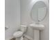 Powder room featuring a pedestal sink, an oval mirror and a water closet, adding a touch of elegance to the space at 462 Fox Sparrow Ct, Summerville, SC 29486