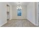 Open dining room with gray floors, a window and a modern chandelier at 462 Fox Sparrow Ct, Summerville, SC 29486