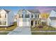 Charming two-story home with blue siding, a two-car garage, and well-manicured landscaping at 462 Fox Sparrow Ct, Summerville, SC 29486