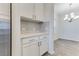 Additional kitchen cabinet storage beside stainless-steel refrigerator at 462 Fox Sparrow Ct, Summerville, SC 29486