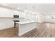 Bright kitchen features white cabinets, stainless steel appliances, a large island and modern pendant lighting at 468 Cadbury Loop, Summerville, SC 29486