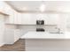 Bright kitchen features white cabinets, stainless steel appliances, a large island and modern pendant lighting at 468 Cadbury Loop, Summerville, SC 29486