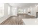 Open concept living room and kitchen features a modern fireplace and ample natural light at 468 Cadbury Loop, Summerville, SC 29486