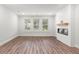 Bright living room with a modern fireplace and large windows at 468 Cadbury Loop, Summerville, SC 29486