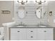Elegant bathroom featuring a double vanity with granite countertops and framed mirrors at 4852 Rocking Porch Ln, Summerville, SC 29485