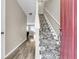 Warm entryway with decorative carpet on the stairs and durable laminate flooring in the hall at 4852 Rocking Porch Ln, Summerville, SC 29485