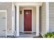 Inviting front door with white pillars providing an entryway into this lovely home at 4852 Rocking Porch Ln, Summerville, SC 29485