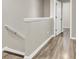 Upstairs hallway with hardwood floors, a white banister, and access to multiple rooms at 4852 Rocking Porch Ln, Summerville, SC 29485