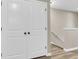 Bright hallway featuring a staircase with white banister and a closet with bi-fold doors and dark hardware at 4852 Rocking Porch Ln, Summerville, SC 29485