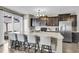 Eat-in kitchen with an island breakfast bar featuring stainless steel appliances and dark wood cabinets at 4852 Rocking Porch Ln, Summerville, SC 29485