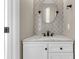 Stylish half bathroom with an oval mirror and a white marble vanity at 4852 Rocking Porch Ln, Summerville, SC 29485