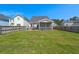 Spacious backyard featuring well-maintained lawn, patio, and fenced perimeter at 546 Alderly Dr, Moncks Corner, SC 29461