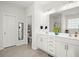 Bright bathroom featuring a double vanity, large mirror, and access to additional facilities at 546 Alderly Dr, Moncks Corner, SC 29461