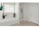 Well-lit bathroom showcasing a bathtub and glass-enclosed shower, ideal for relaxation at 546 Alderly Dr, Moncks Corner, SC 29461