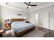 Comfortable bedroom featuring tray ceilings, ceiling fan, and ensuite bathroom access at 546 Alderly Dr, Moncks Corner, SC 29461