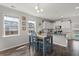 Charming dining area featuring a blue table set, wood floors, and natural light from adjacent windows at 546 Alderly Dr, Moncks Corner, SC 29461