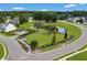 Aerial view of a community dog park with lush green grass near the lake and neighborhood homes at 546 Alderly Dr, Moncks Corner, SC 29461