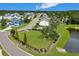 Aerial shot of the dog park with lush green grass near the lake and homes in the community at 546 Alderly Dr, Moncks Corner, SC 29461
