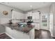Modern kitchen boasts white cabinets, stainless steel appliances, granite countertops, and access to the backyard at 546 Alderly Dr, Moncks Corner, SC 29461