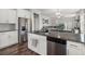 Spacious kitchen island connects the modern kitchen and cozy living room with hardwood floors at 546 Alderly Dr, Moncks Corner, SC 29461