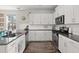 Bright kitchen features granite countertops, white cabinets, stainless steel appliances, and hardwood flooring at 546 Alderly Dr, Moncks Corner, SC 29461